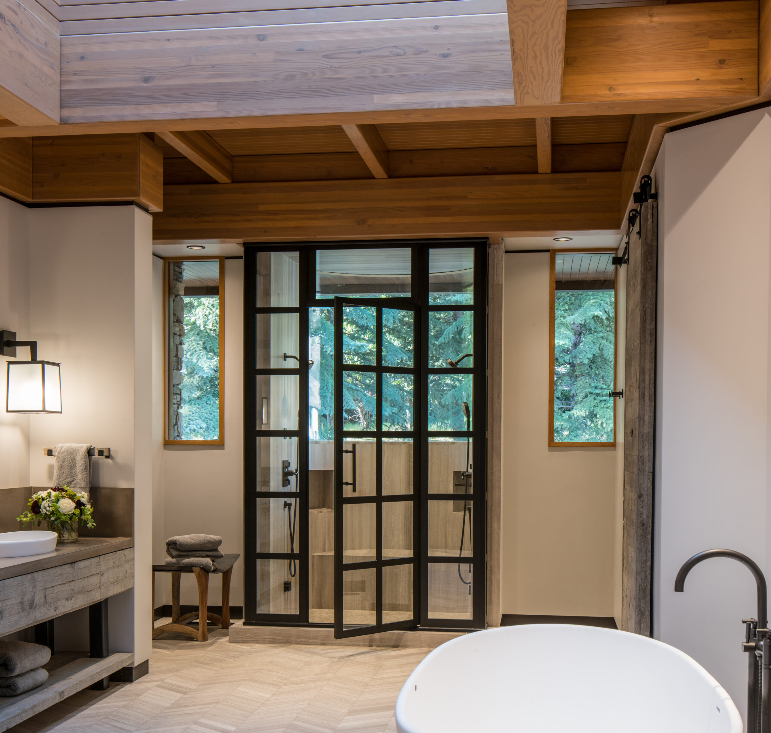 bathroom with a free standing tub, and french doors leading into the shower