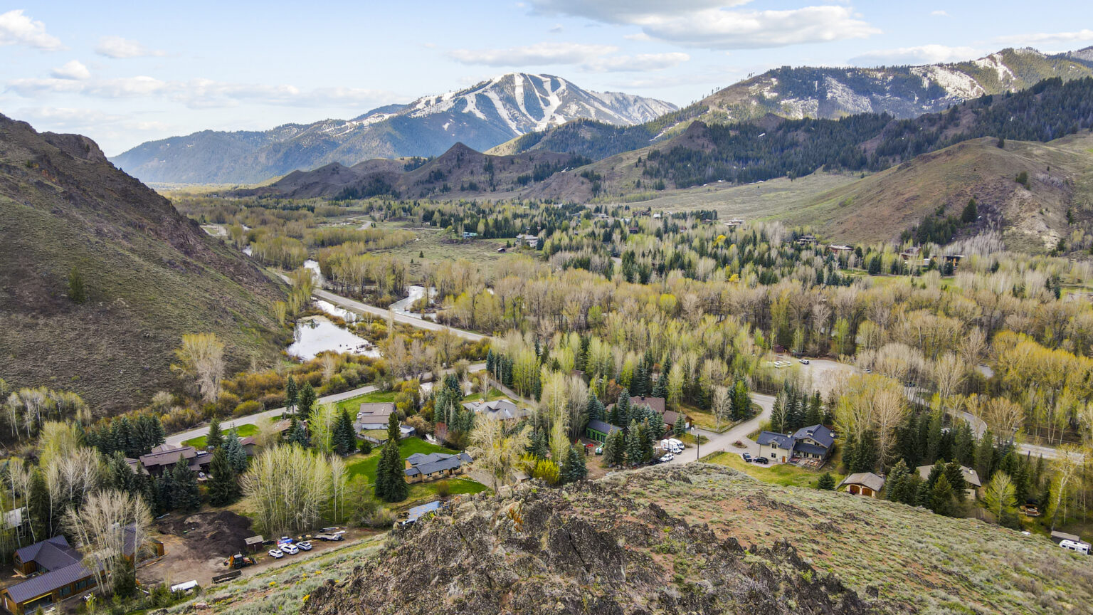 Drone shot of in progress custom home construction project in sun valley idaho with bald mountain in the back ground, value engineering