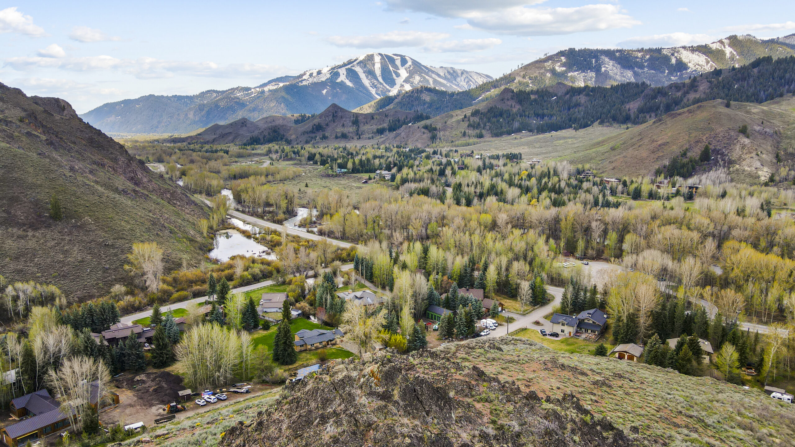 Drone shot of in progress custom home construction project in sun valley idaho with bald mountain in the back ground, value engineering