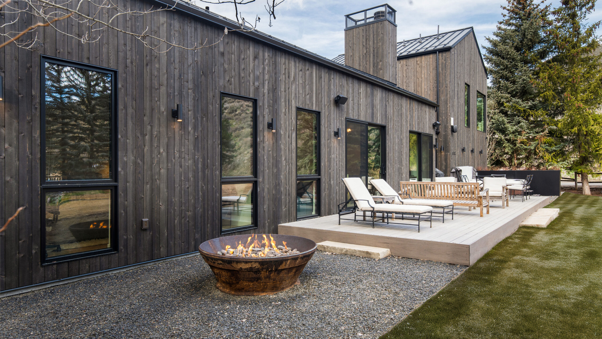 custom home in sun valley idaho back deck with fire pit and chairs